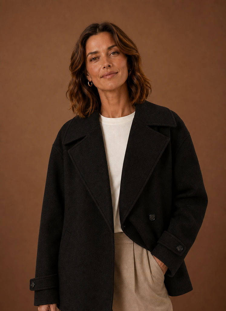 Front view of women's long, loose coat with button-front closure