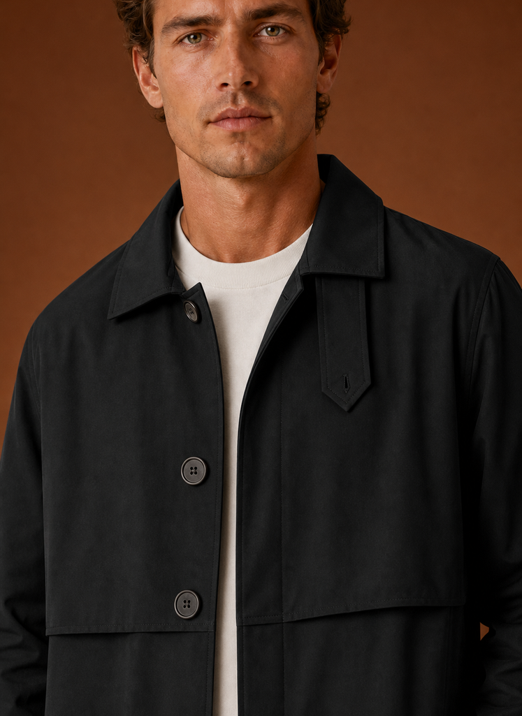 Close-up of the collar and upper front of a black men's trench coat