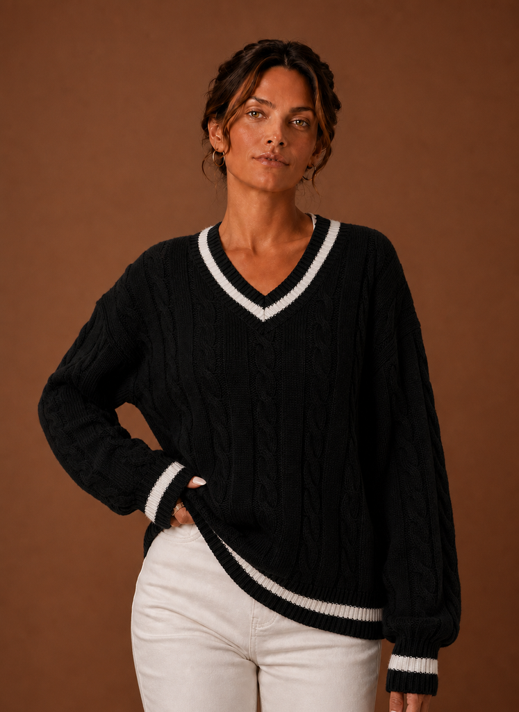Front view of women's cable knit V-neck sweater on mannequin showing V-neck and textured knit
