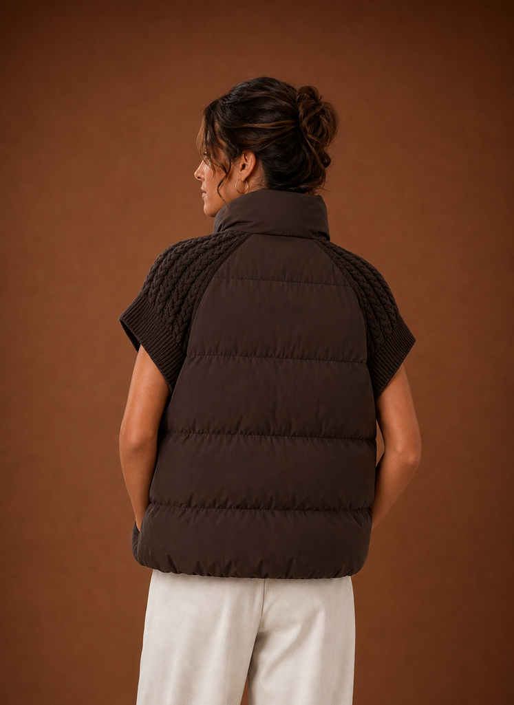Back view of women's puffer vest highlighting padded body and shoulder detail