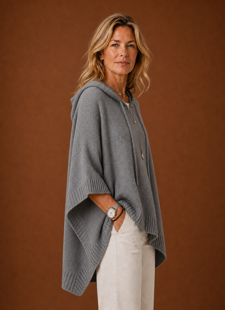 Side profile of hooded pullover highlighting oversized silhouette and sleeve length