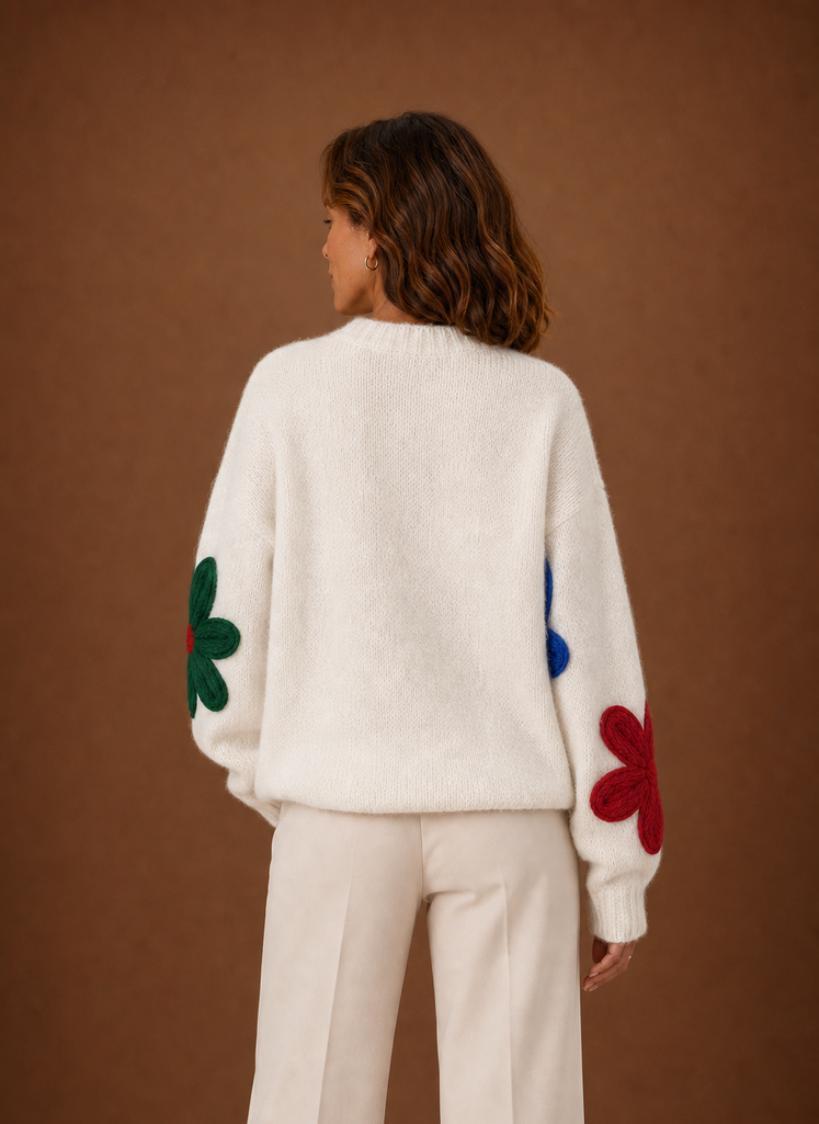 Back view of white oversized floral knit sweater showing full floral knit pattern across the back